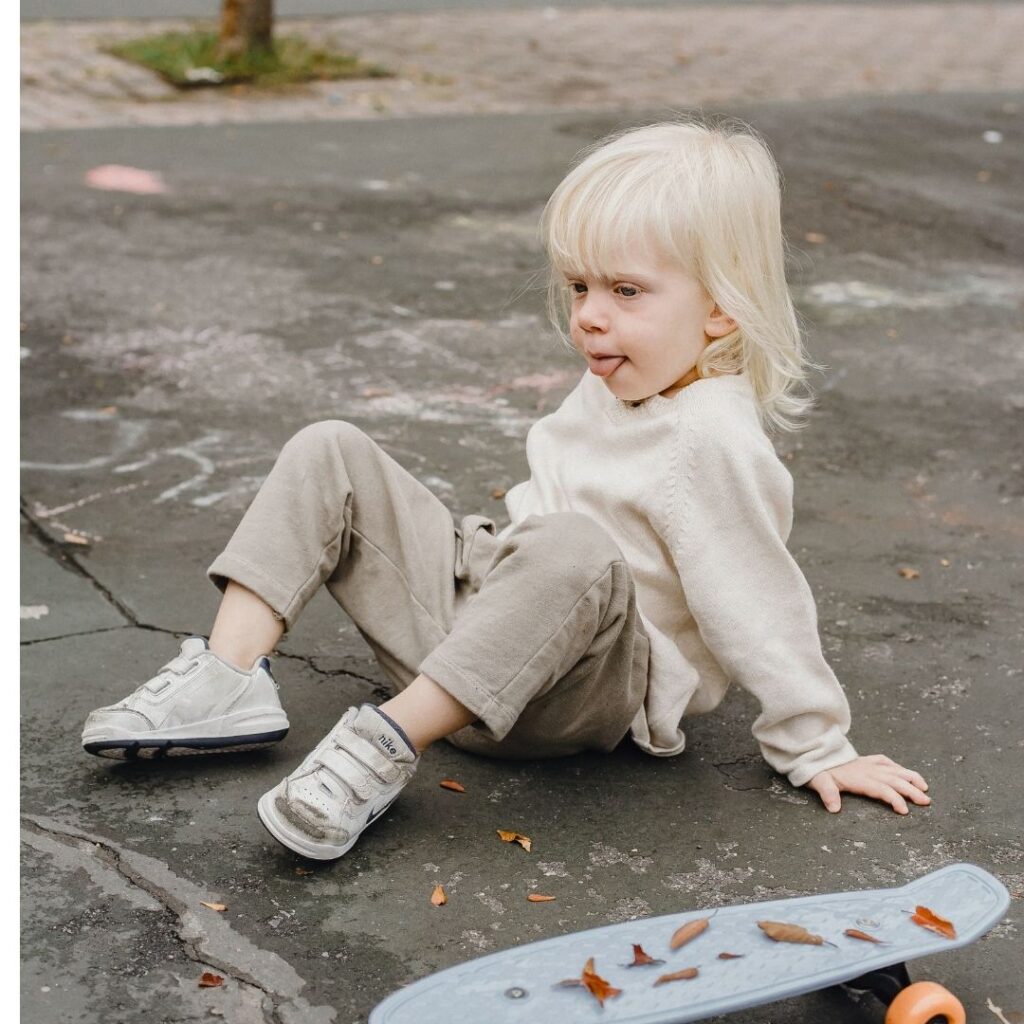girl falls off her skateboard due to buckling concrete slabs