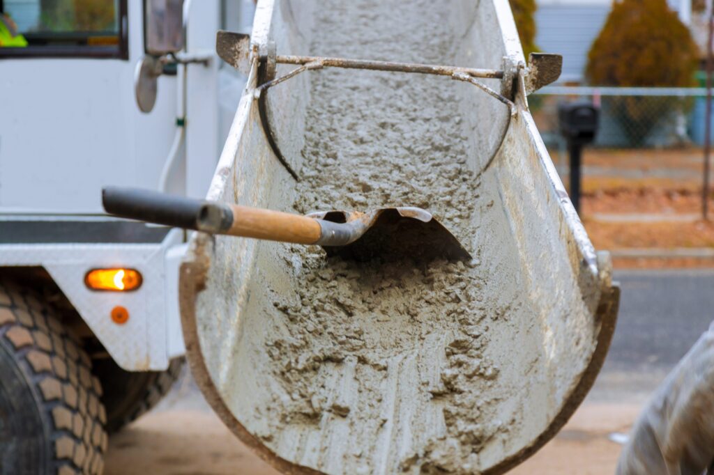 Concrete truck with pouring cement during to residential street